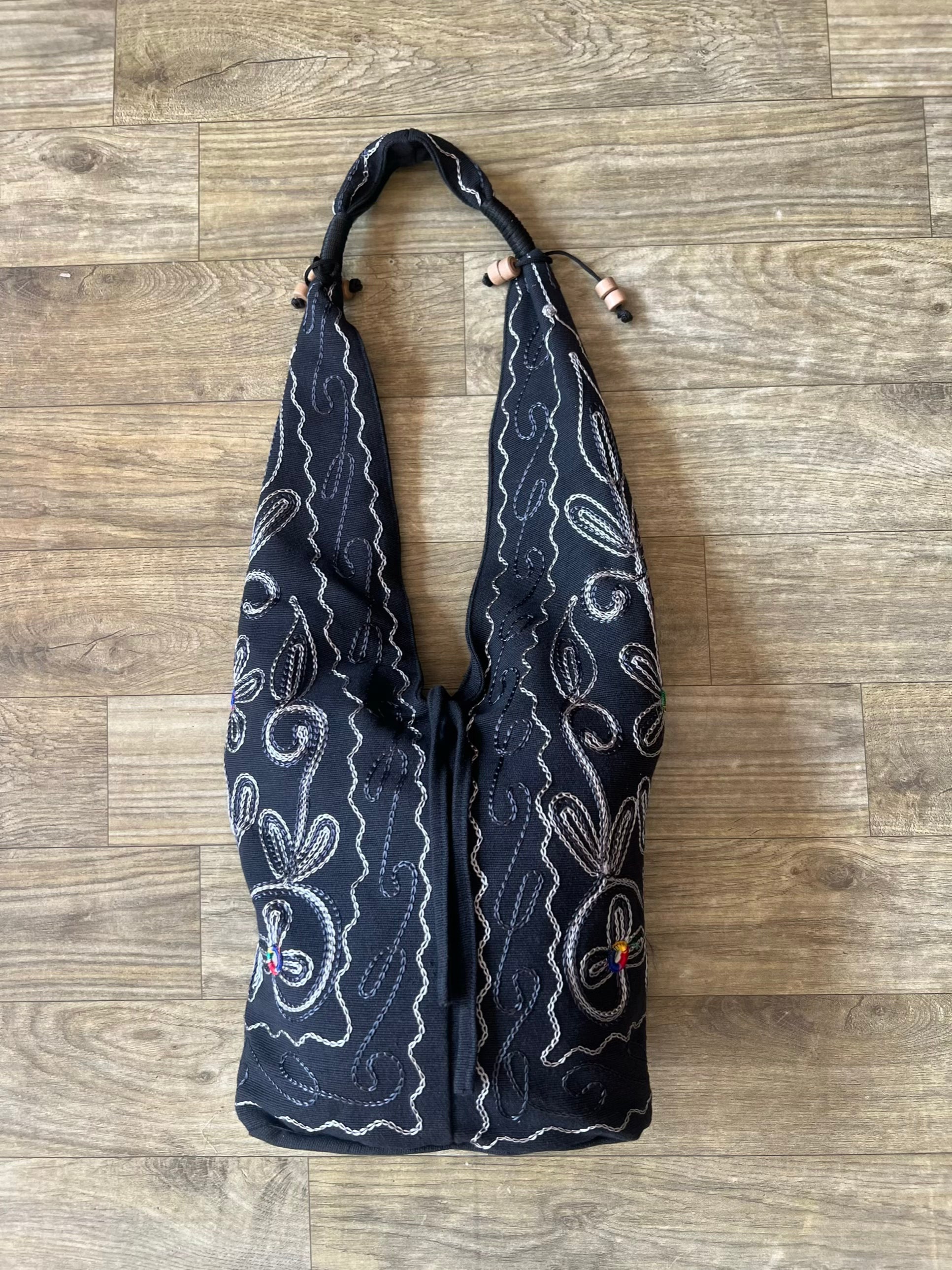 Handmade embroidered hobo bag with colorful floral threadwork and bohemian design