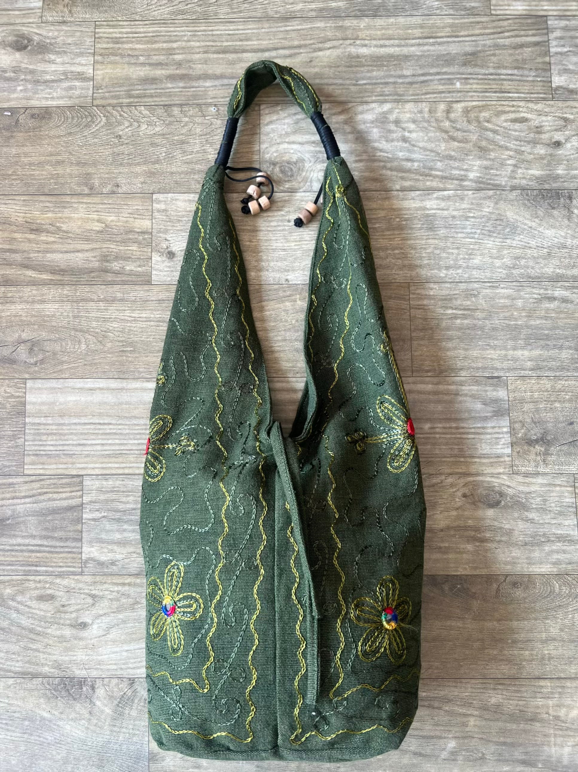 Handmade embroidered hobo bag with colorful floral threadwork and bohemian design
